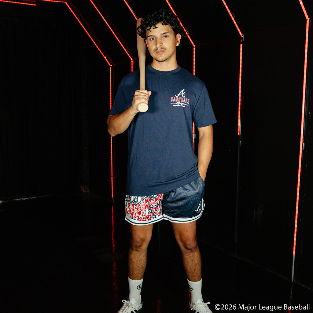 Adult model wearing navy shorts with "Atlanta Braves Sticker Court" design