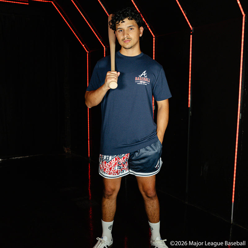 Adult model wearing navy shorts with "Atlanta Braves Sticker Court" design