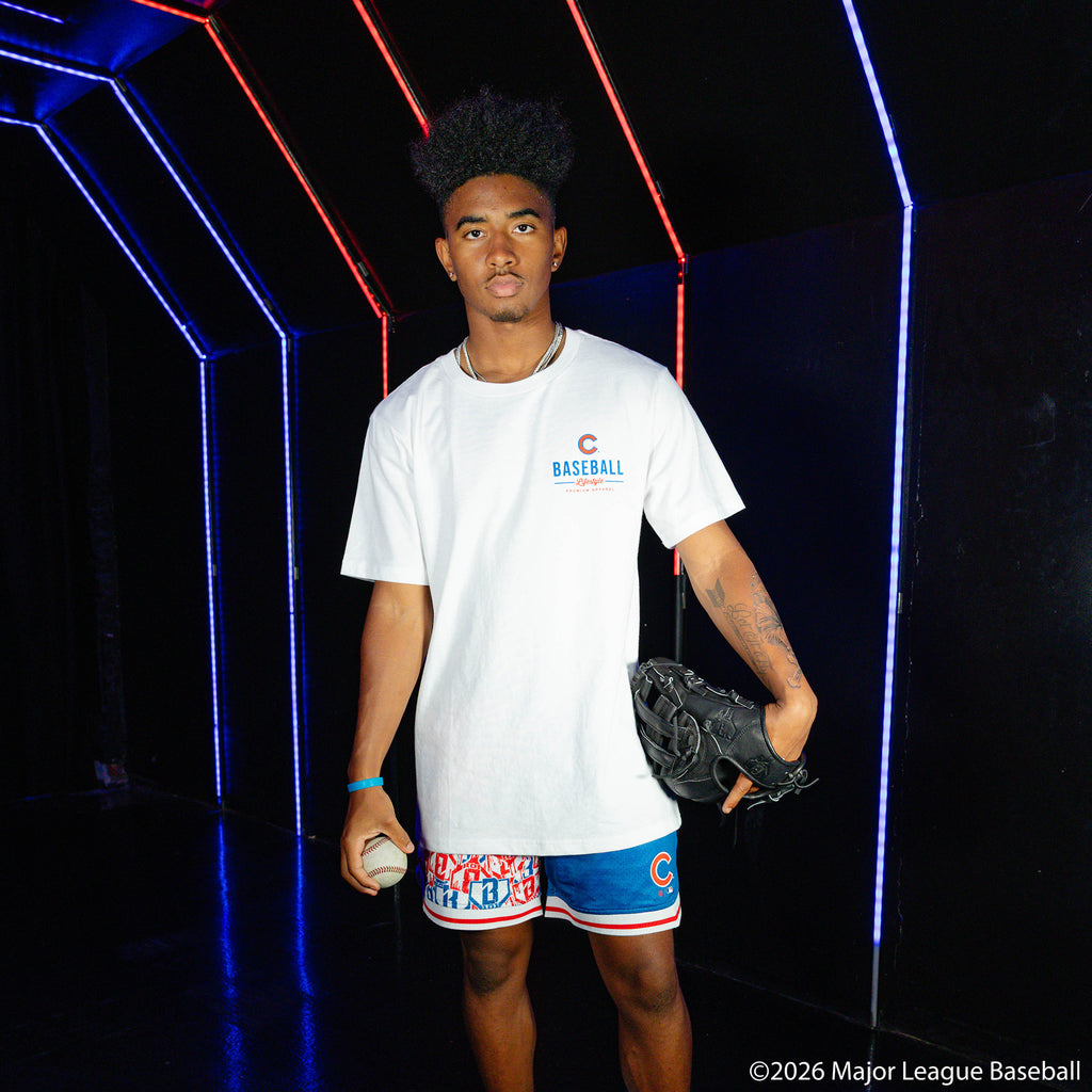 Adult model wearing blue shorts with "Chicago Cubs Sticker Court" design