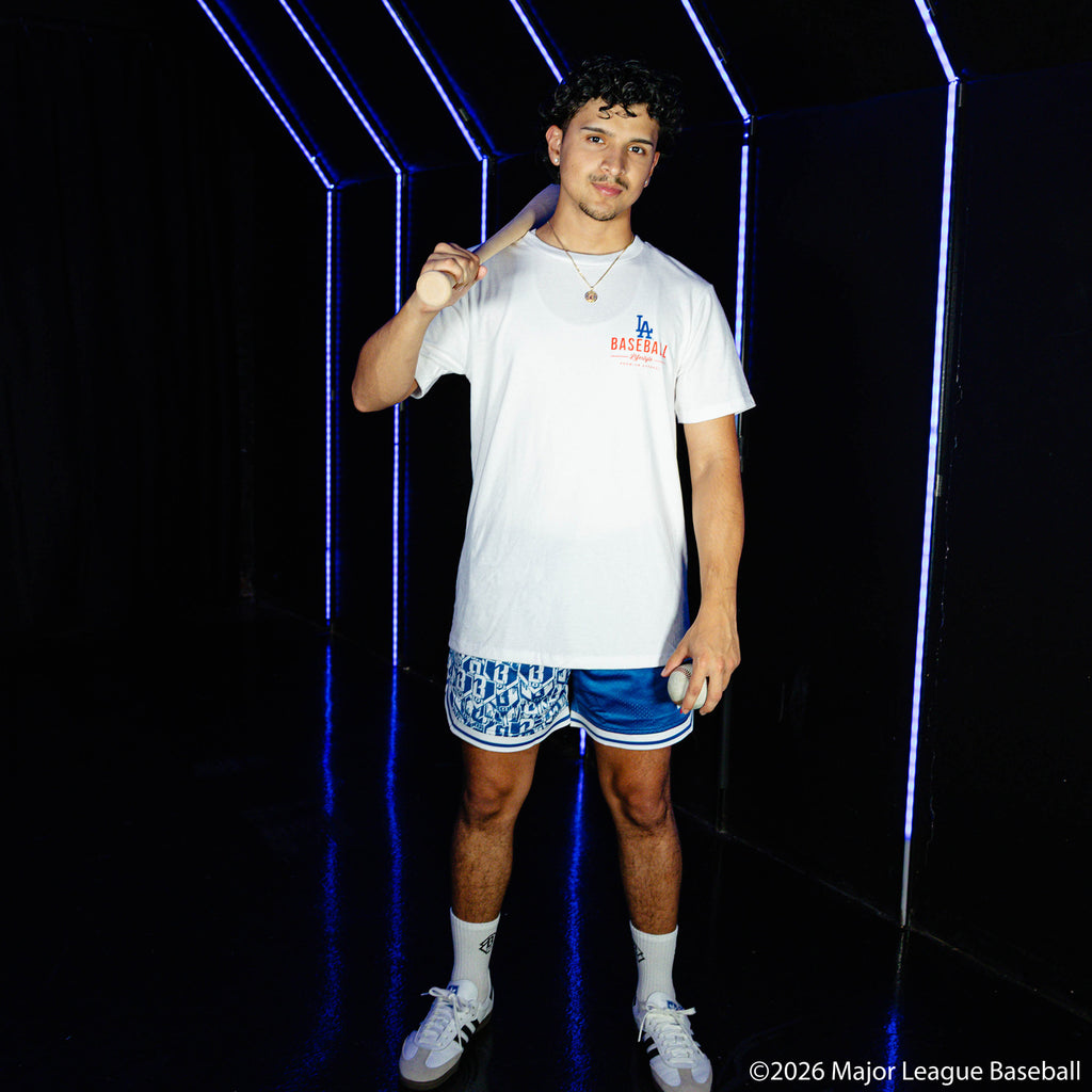 Adult model wearing blue shorts with "Los Angeles Dodgers Sticker Court" design