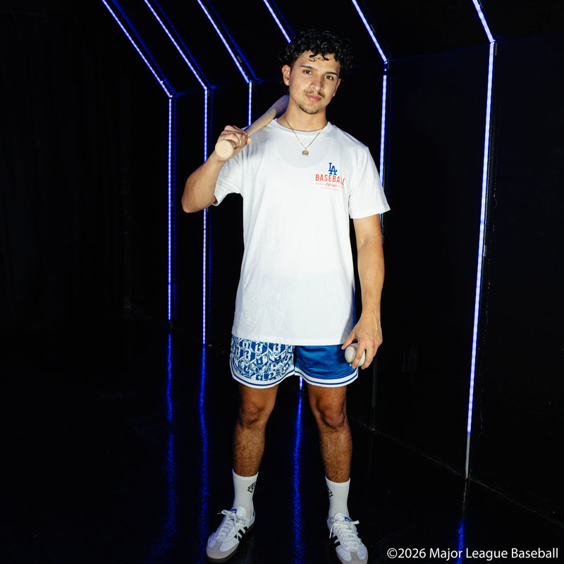 Adult model wearing blue shorts with "Los Angeles Dodgers Sticker Court" design