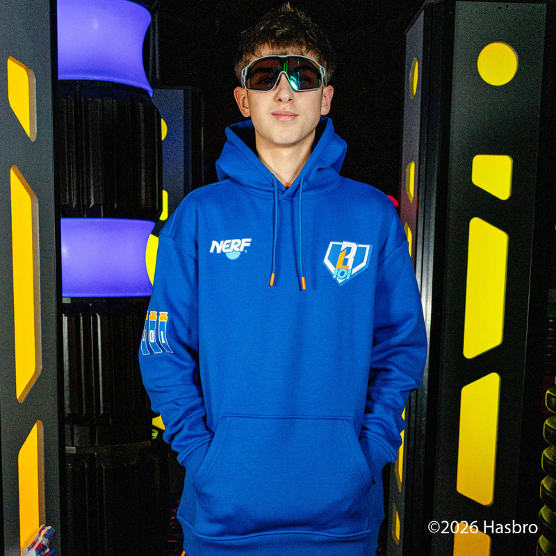 Person wearing a blue hoodie with a NERF X BL101 logo, standing in front of colorful geometric background