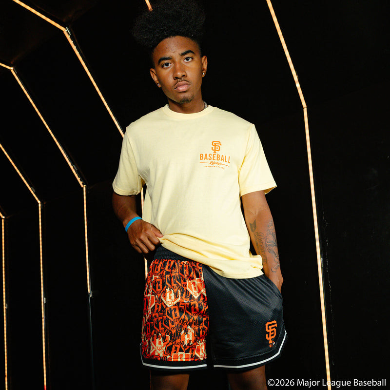 Adult model wearing black shorts with "San Francisco Giants Sticker Court" design