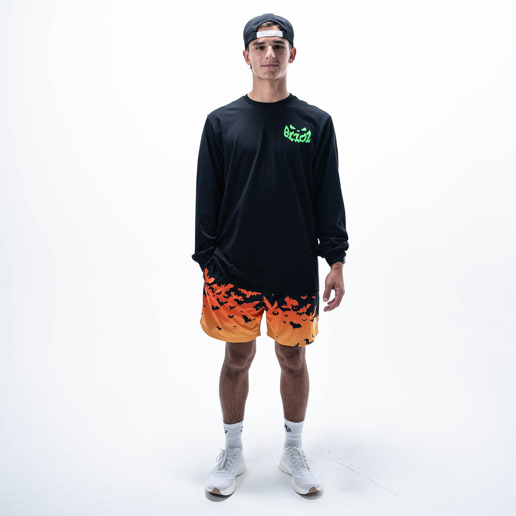 Adult model wearing black long sleeve tee with "Jack O' Lantern Team" design