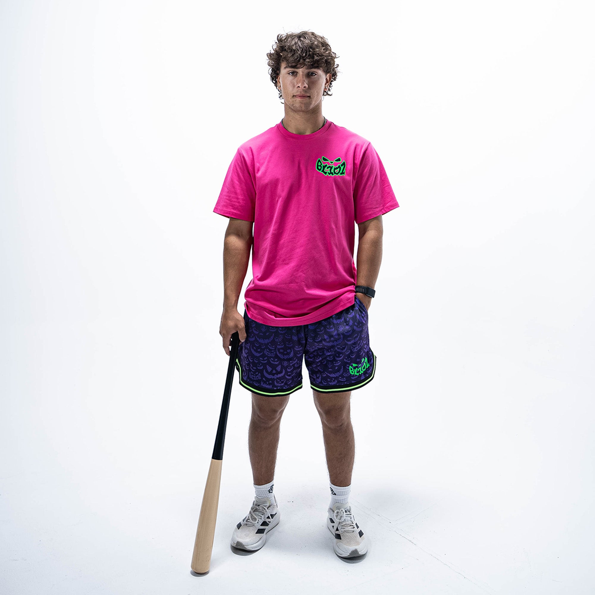 Adult model wearing pink graphic tee with "Jack O' Lantern Team" design