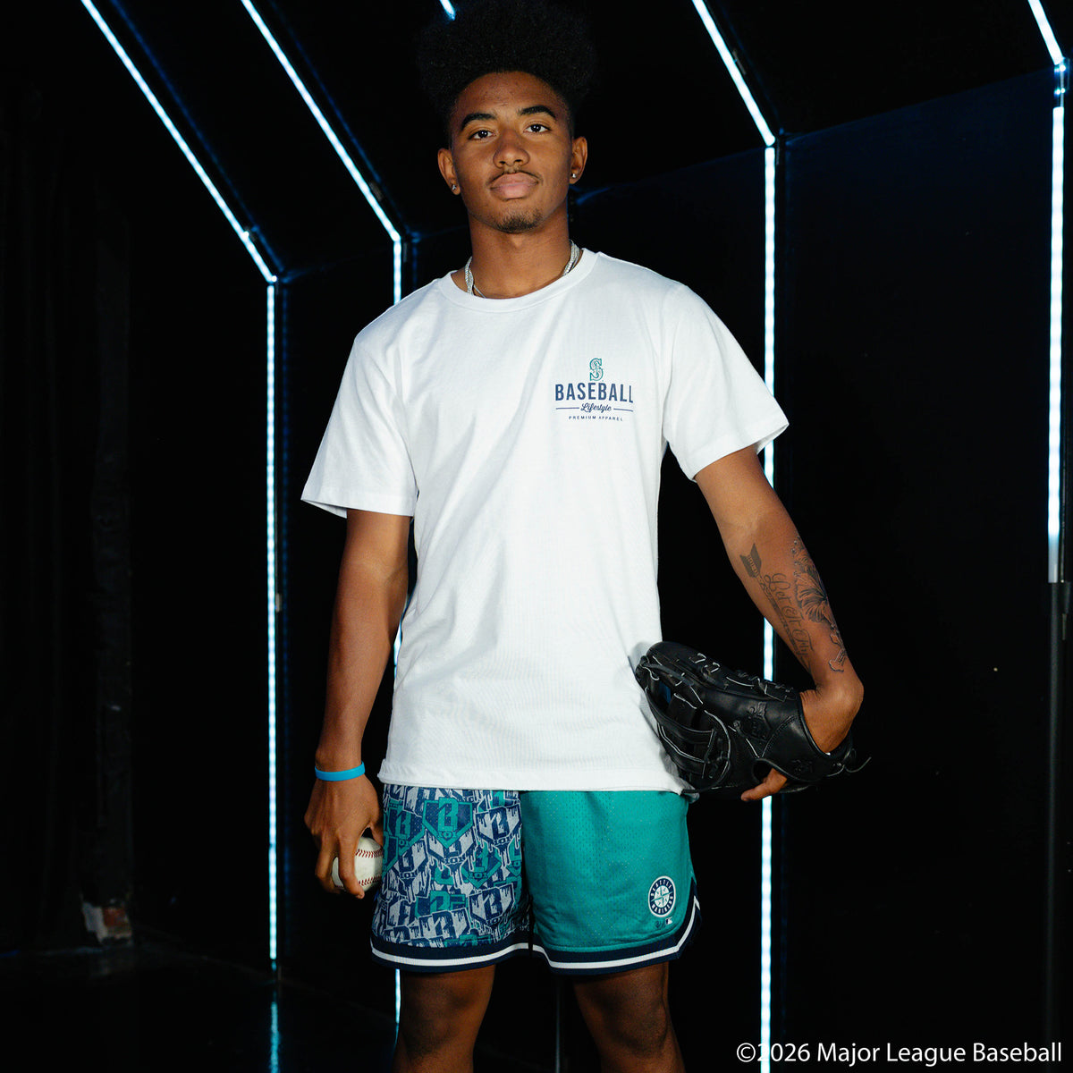 Adult model wearing white graphic tee with "Seattle Mariners Ice Cream Cap" design
