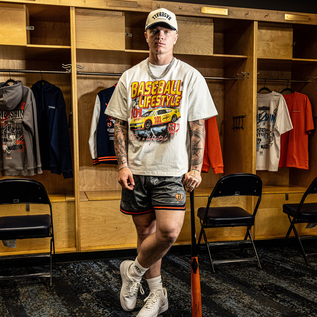 Person wearing a 'Baseball Lifestyle' t-shirt in a locker room.
