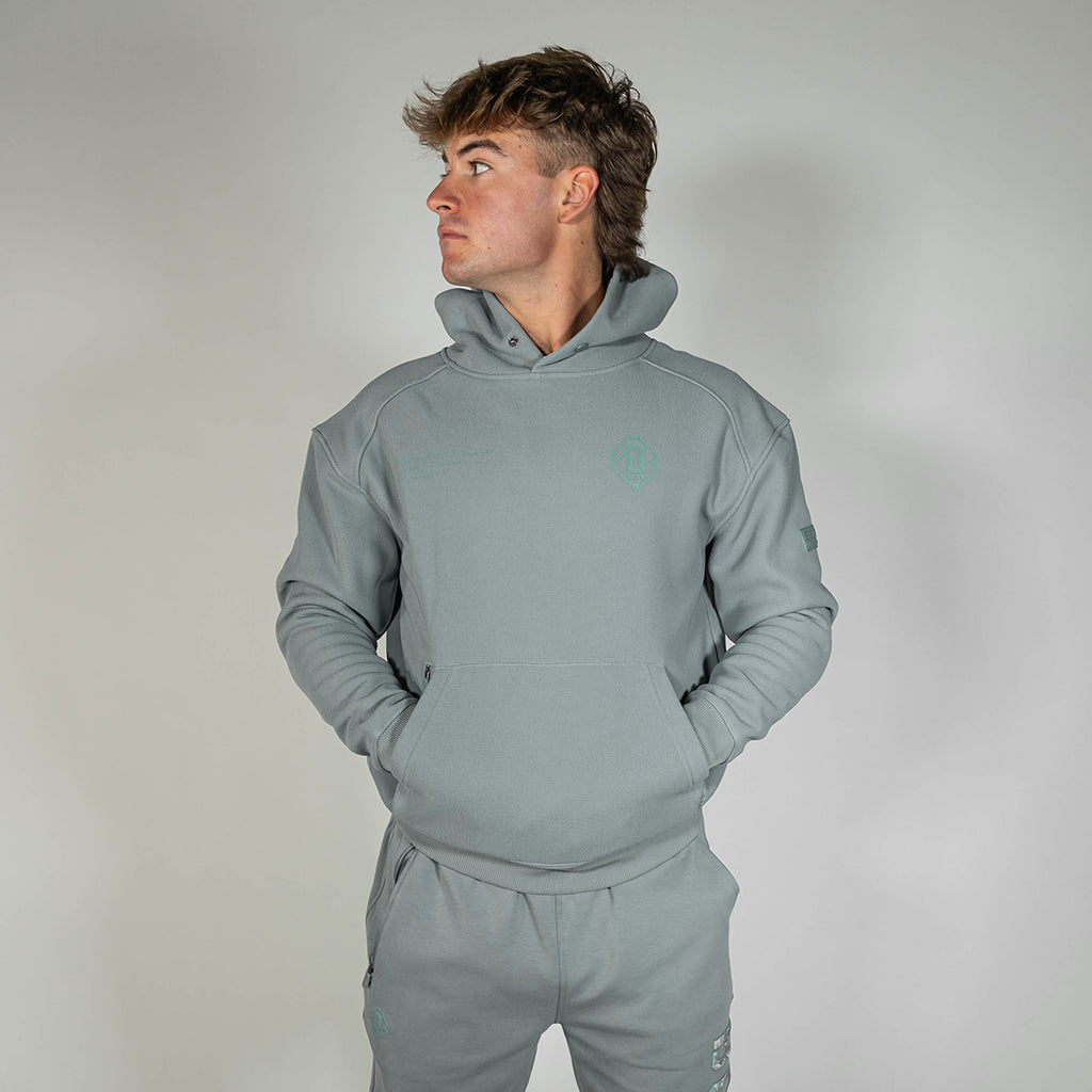 Adult model wearing gray Realtree Aspect Off-Field Waffle Performance Camo hoodie