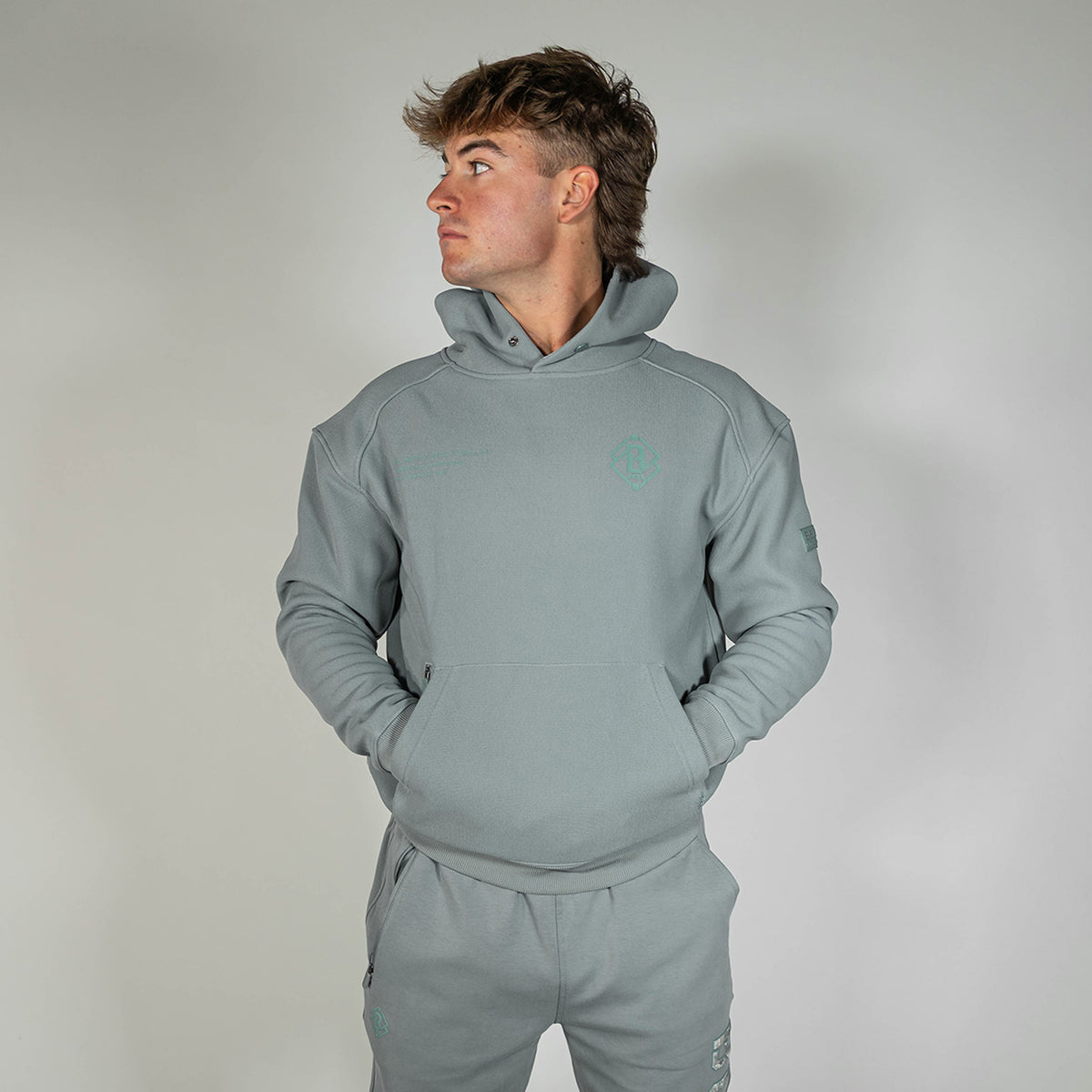 Adult model wearing gray Realtree Aspect Off-Field Waffle Performance Camo hoodie