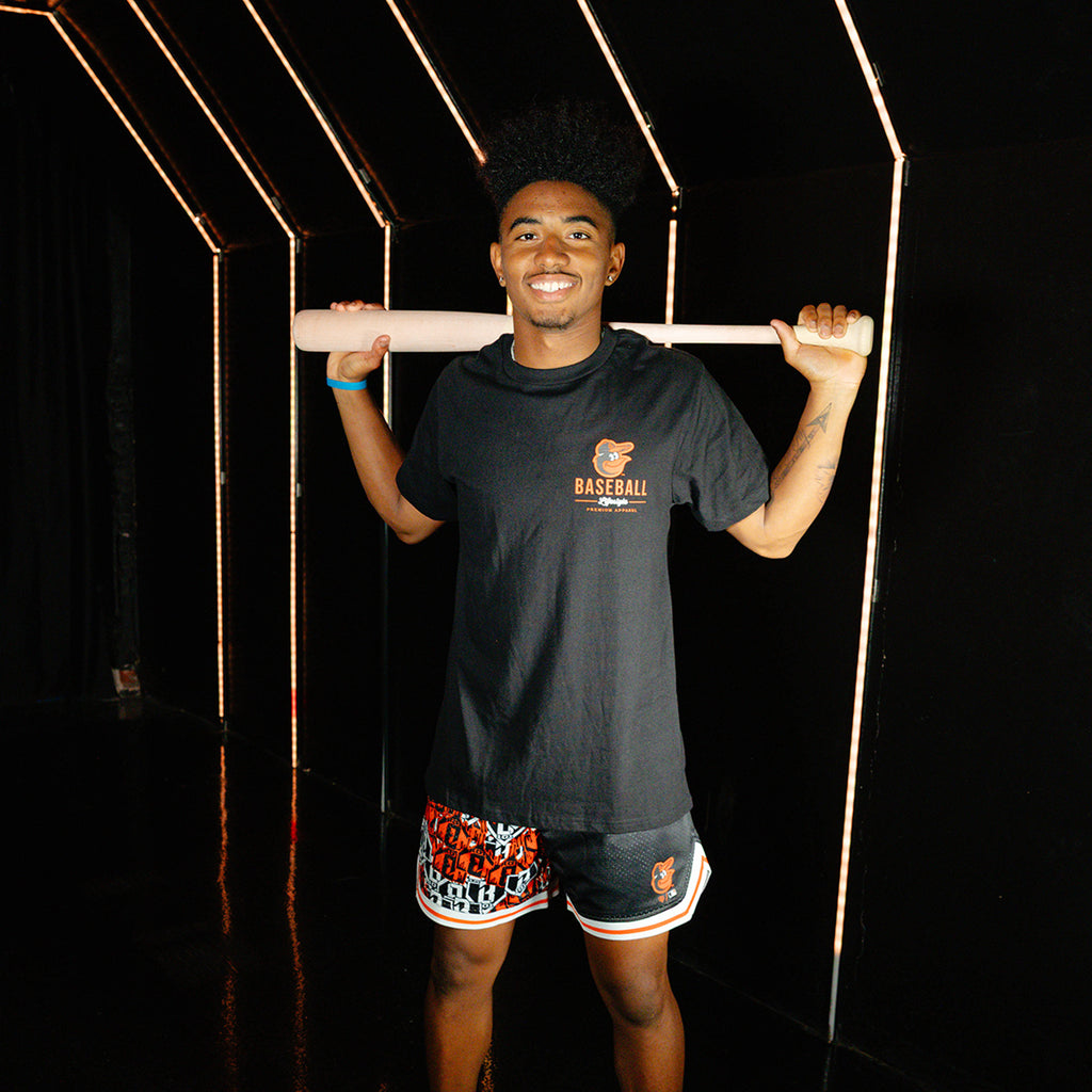Adult model wearing black graphic tee with "Baltimore Orioles Ice Cream Cap" design