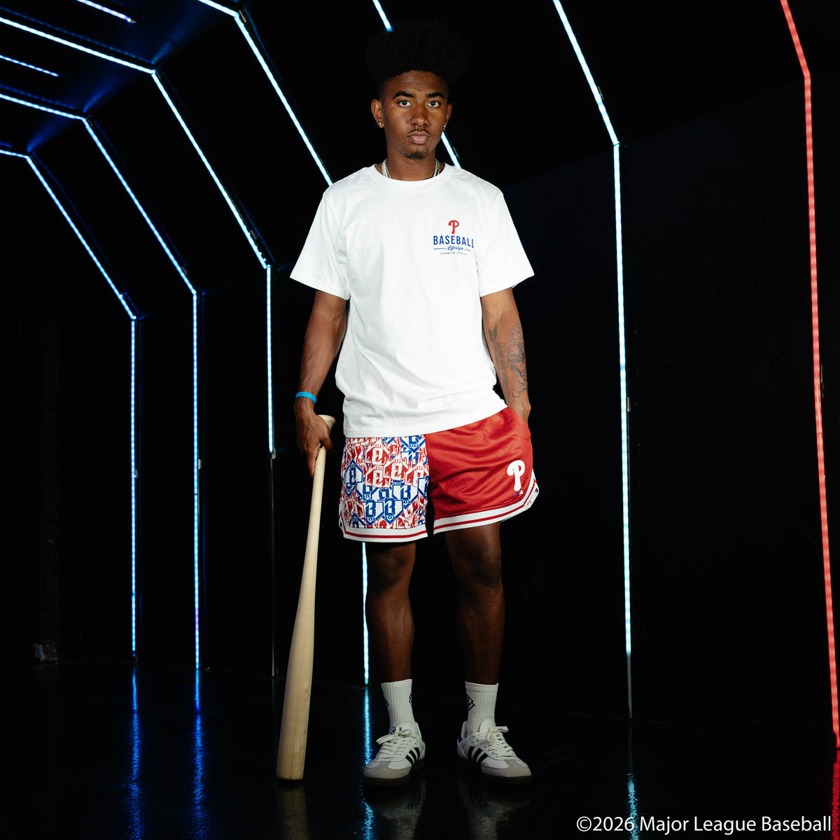 Adult model wearing red shorts with "Philadelphia Phillies Sticker Court" design