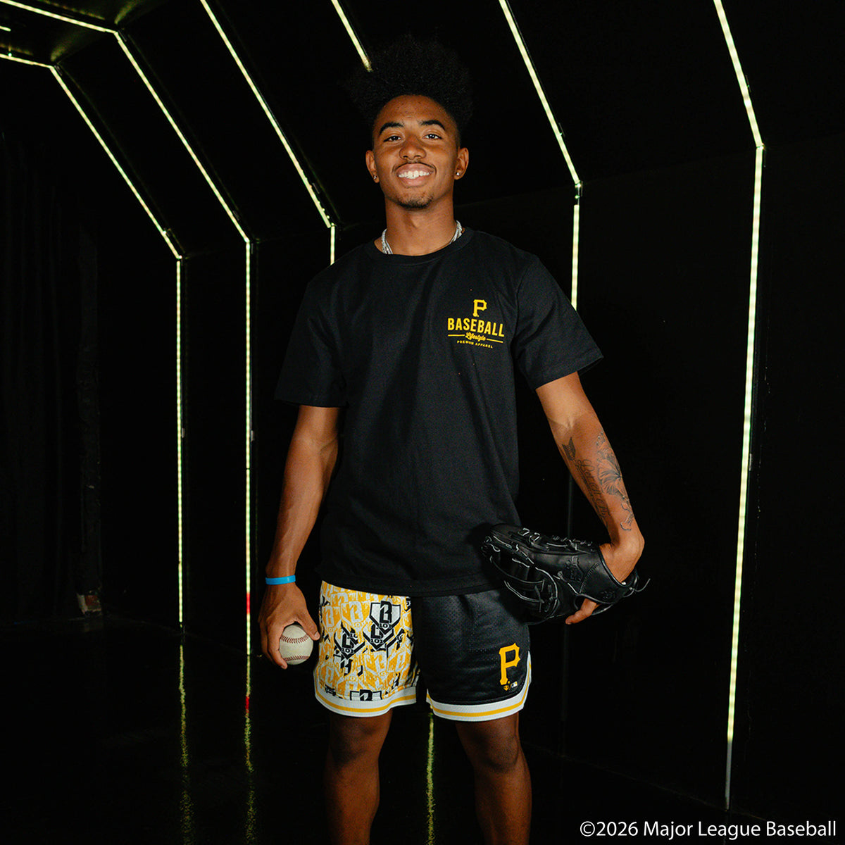 Adult model wearing black shorts with "Pittsburgh Pirates Sticker Court" design