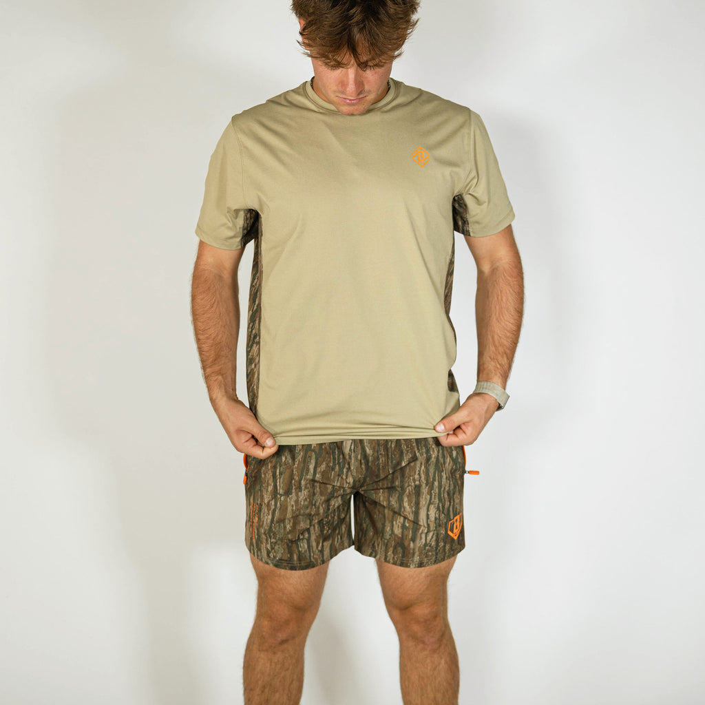 Adult model wearing multi-color Realtree Legacy Pro Series V2 Camo shorts with liner