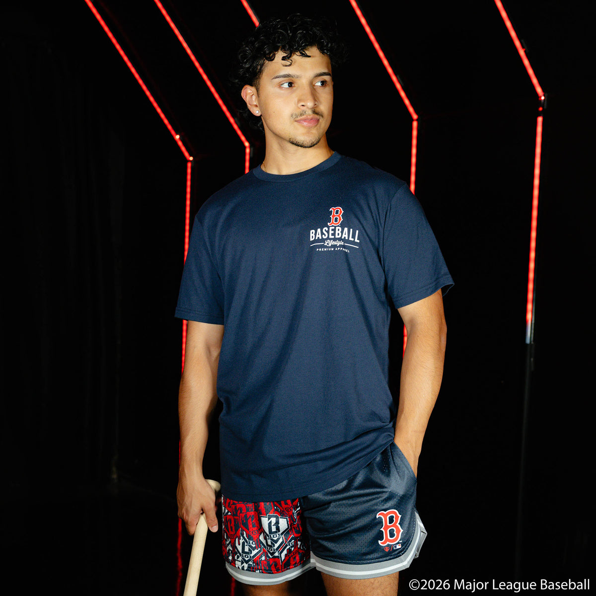 Adult model wearing navy shorts with "Boston Red Sox Sticker Court" design
