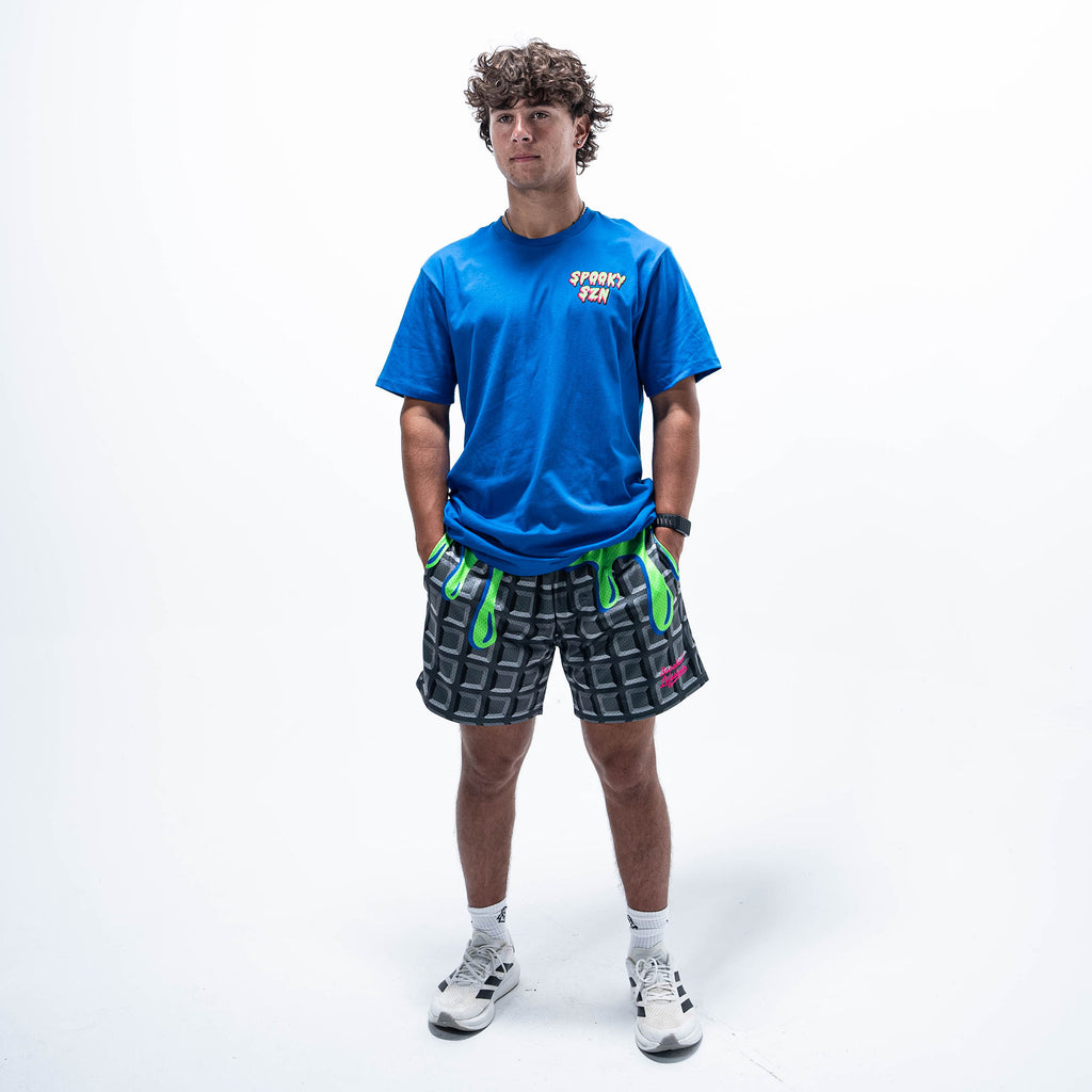 Adult model wearing blue graphic tee with "Spooky SZN Waffle" design