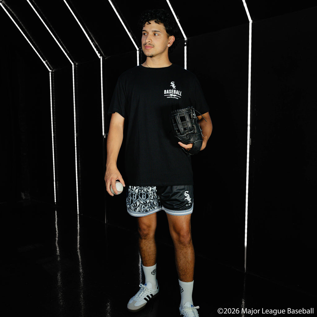 Adult model wearing black shorts with "Chicago White Sox Sticker Court" design