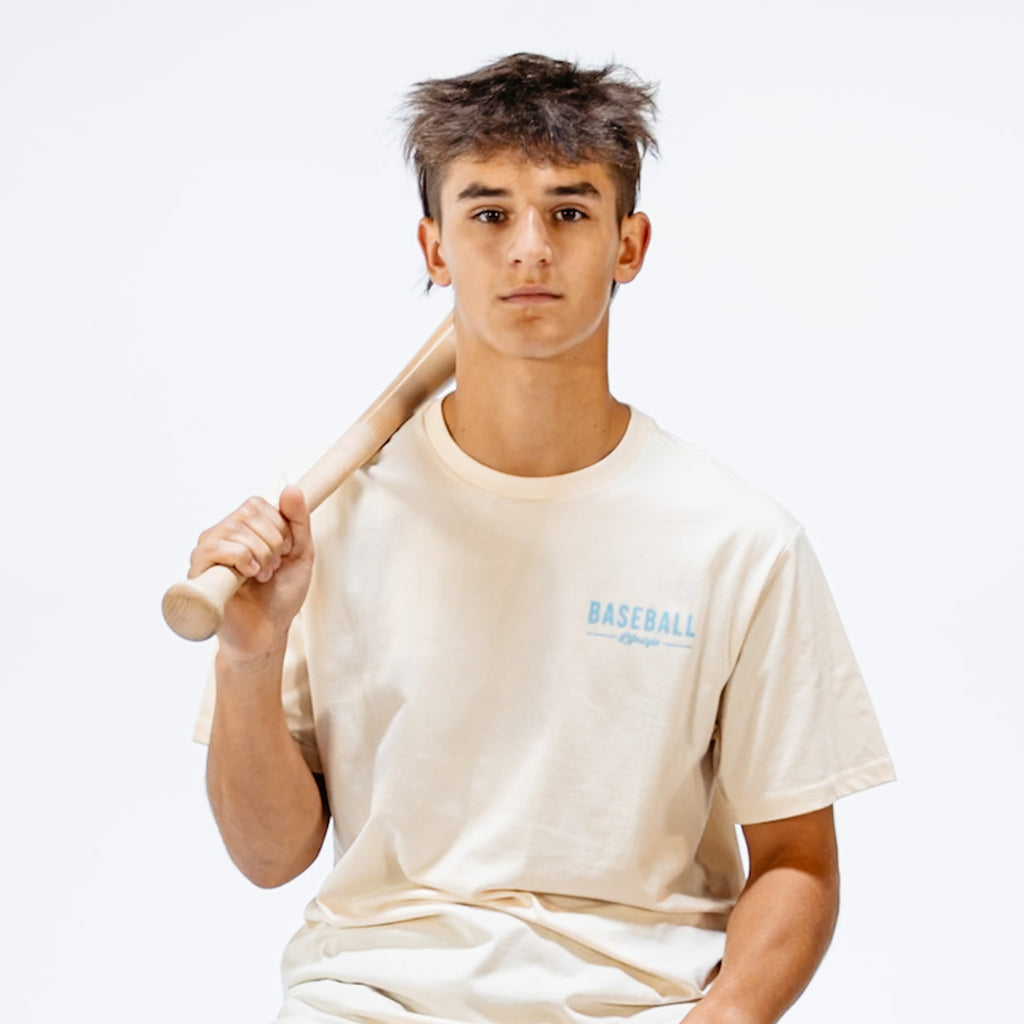 Person holding a baseball bat wearing a 'Baseball Lifestyle' t-shirt on a white background