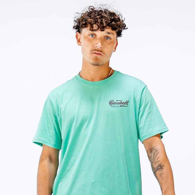Man wearing a green t-shirt with 'Baseball Lifestyle 101' text in top corner 