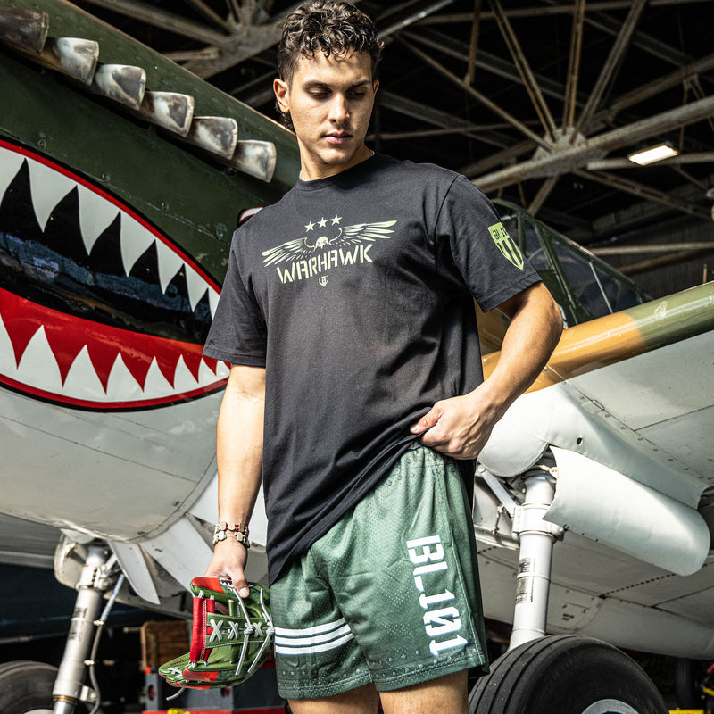 Green athletic shorts with white waistband, BL101 logo on side, and star logo with stripes on bottom, modeled on a person.