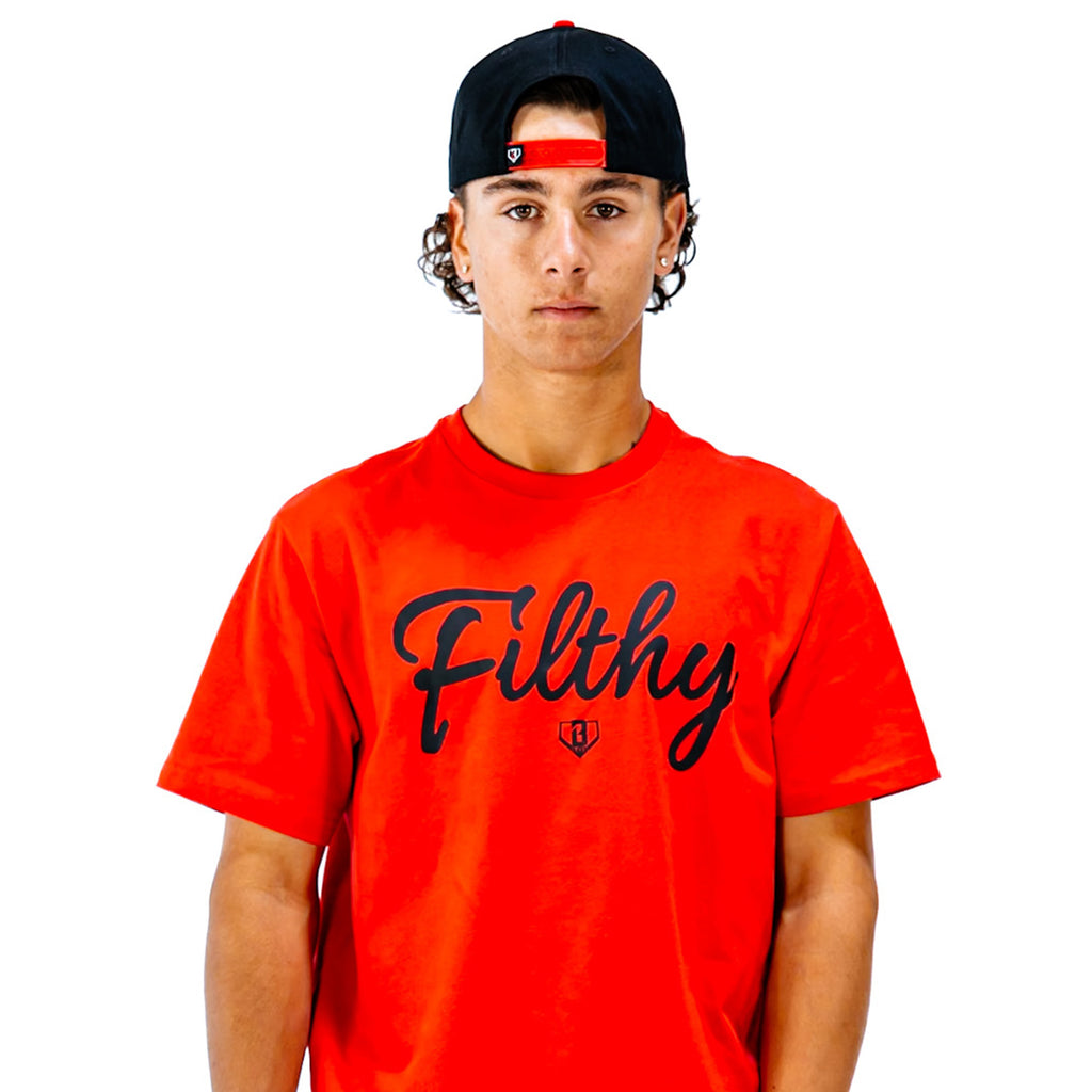 Person wearing a red 'Filthy' t-shirt and black cap with red brim on a white background