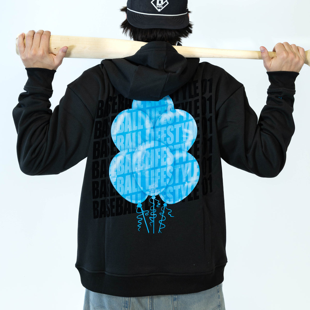 Adult model wearing black hoodie with "10 Year Anniversary" design