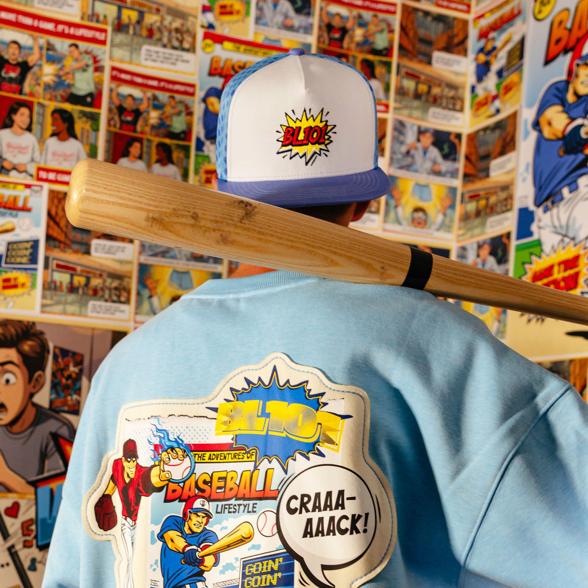 Adult model wearing blue hat with "BL101 Comic" design