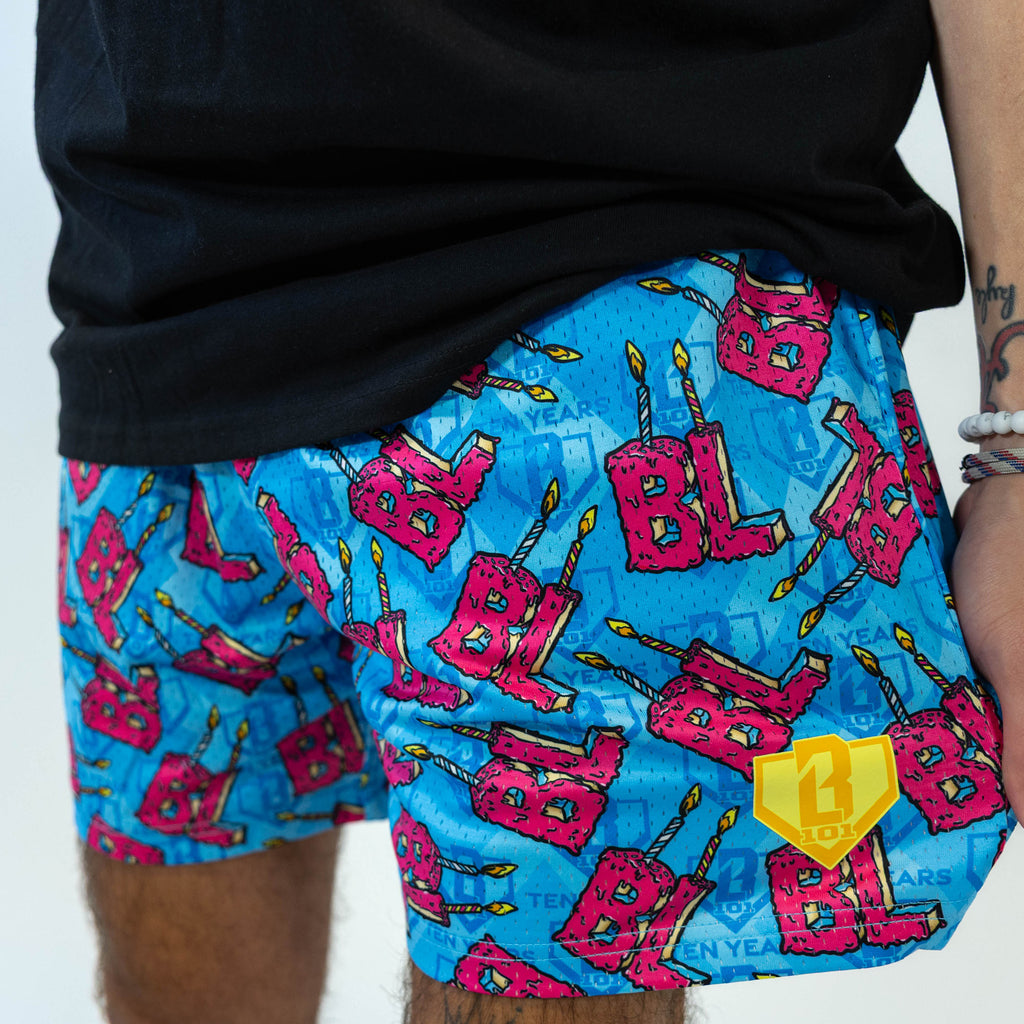 Adult model wearing blue shorts with "BL Birthday" design