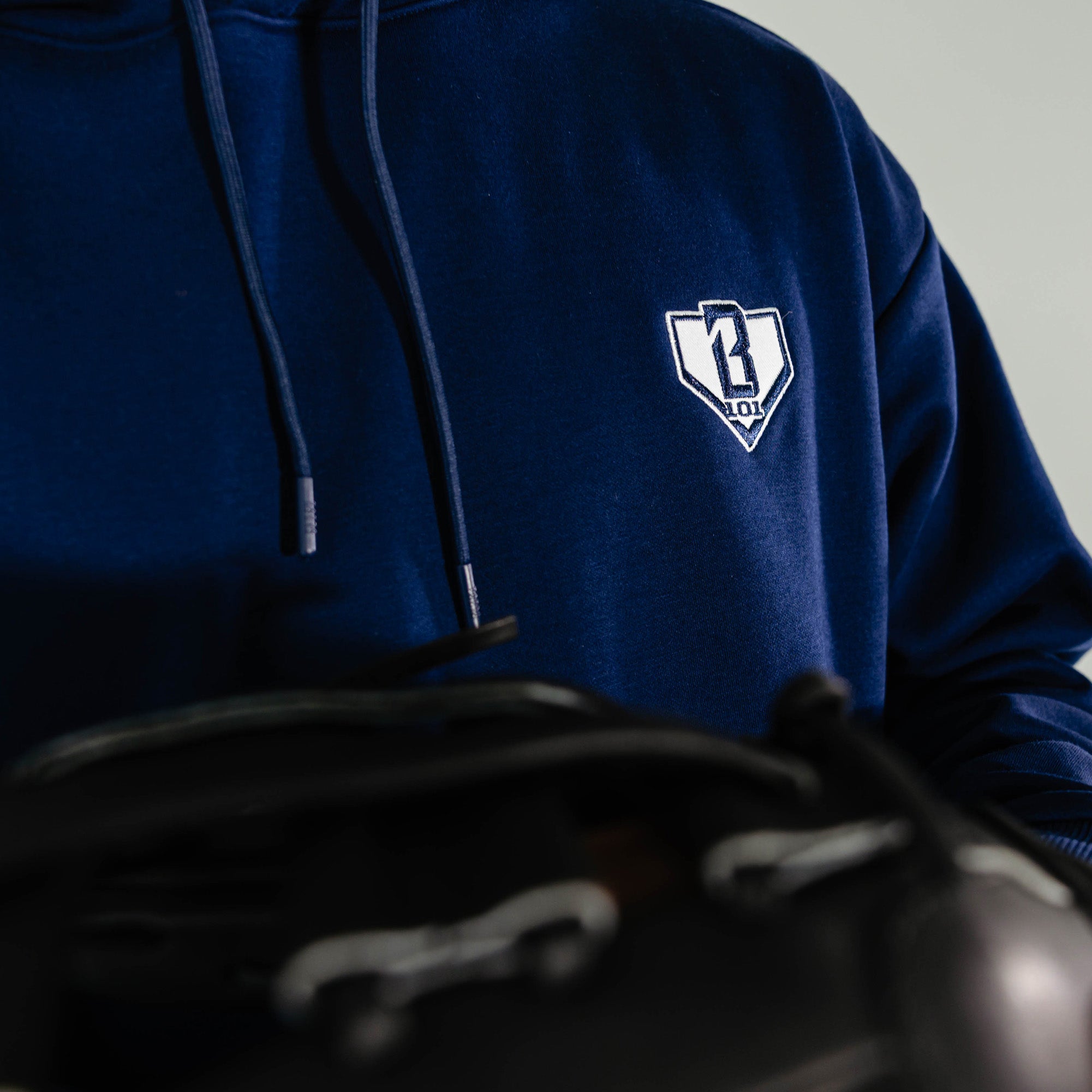 Adult model wearing Navy Baseline hoodie