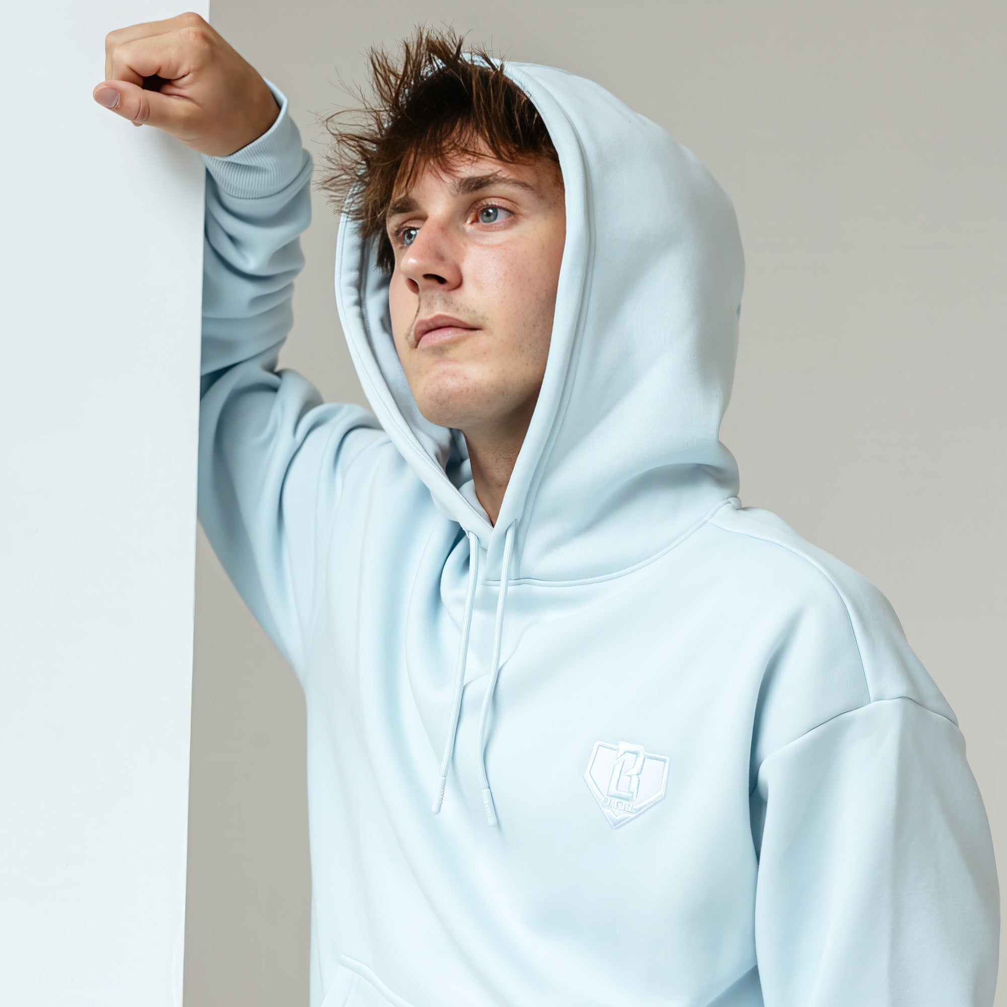 Adult model wearing Blue Baseline hoodie