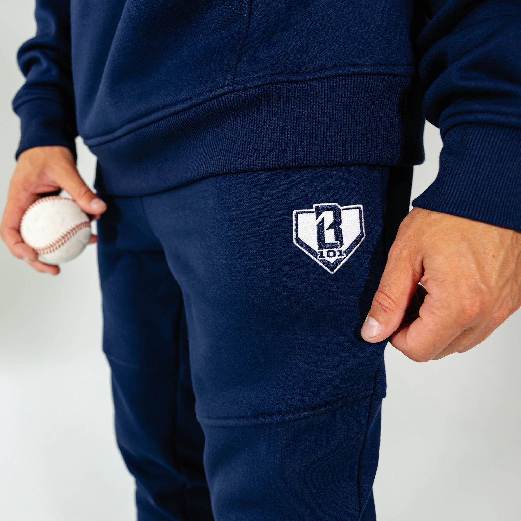 Adult model wearing Navy Baseline joggers