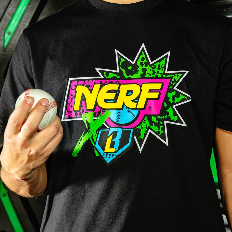 Person wearing a black t-shirt with a colorful 'NERF X BL101' logo, holding a white ball.