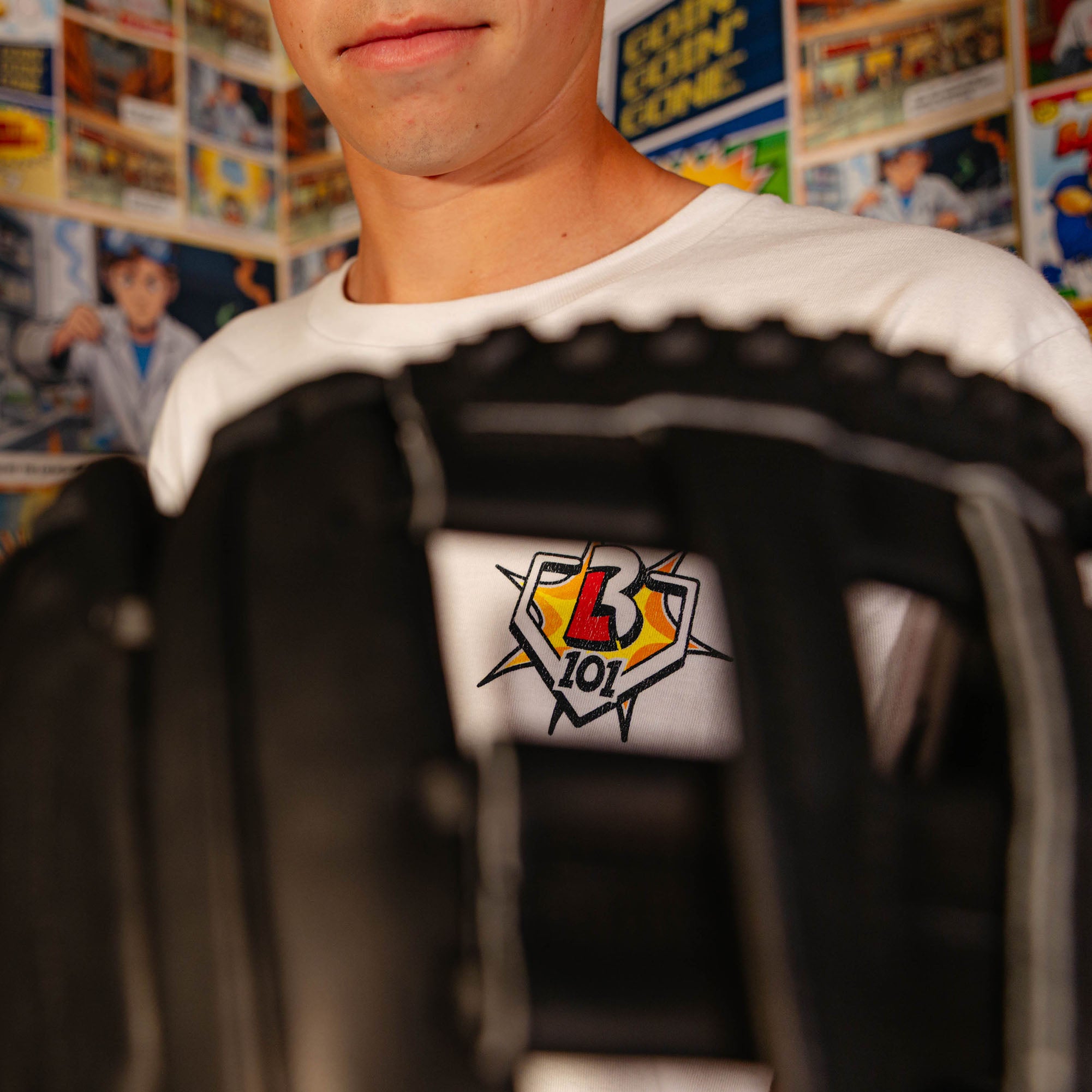 Adult model wearing white graphic tee with "Home Run Hero" design