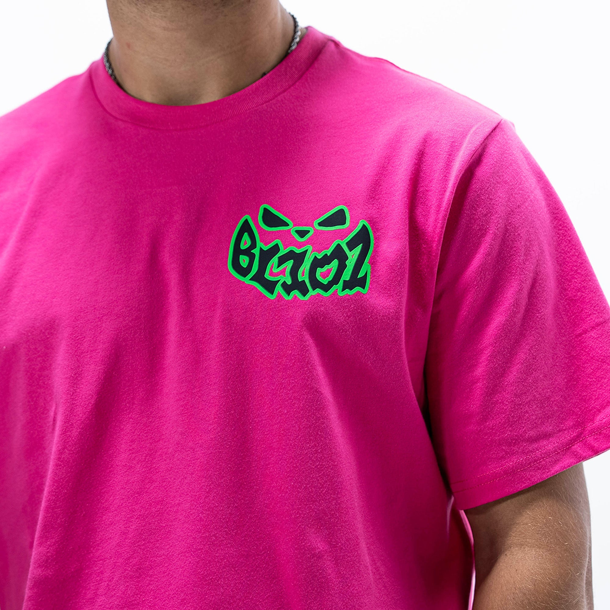 Adult model wearing pink graphic tee with "Jack O' Lantern Team" design