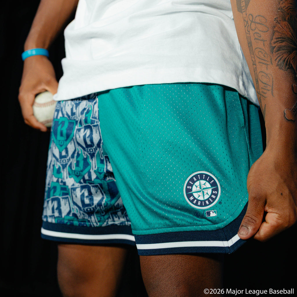 Adult model wearing green shorts with "Seattle Mariners Sticker Court" design