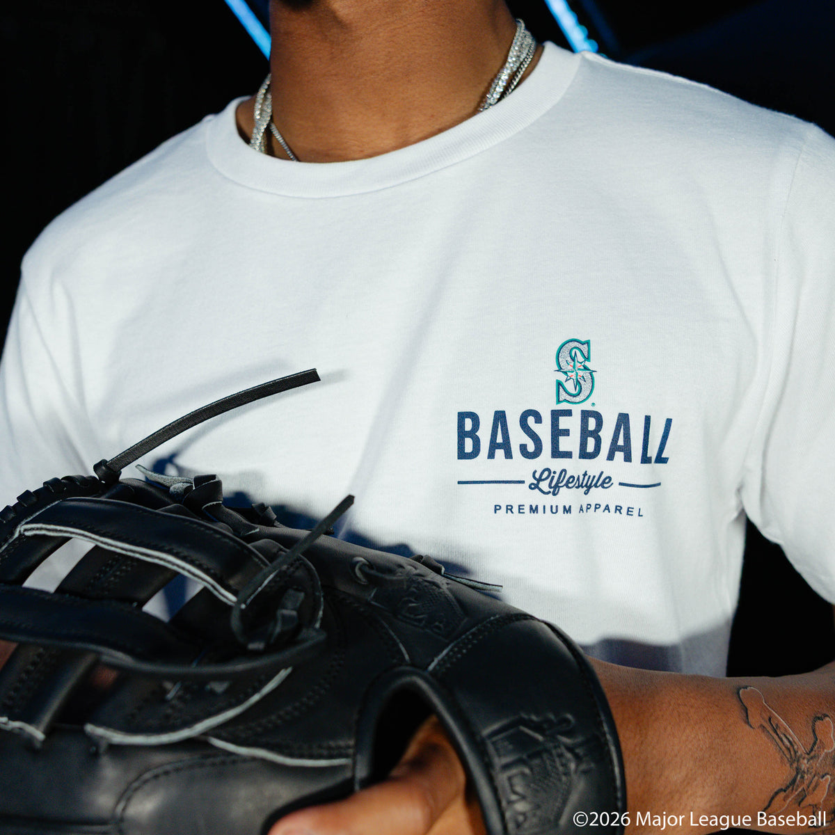 Adult model wearing white graphic tee with "Seattle Mariners Ice Cream Cap" design
