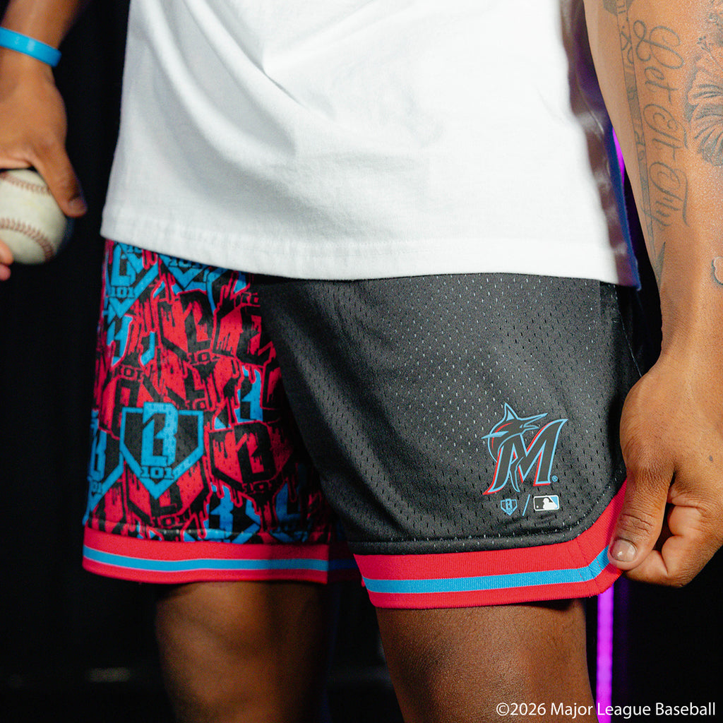 Adult model wearing black shorts with "Miami Marlins Sticker Court" design