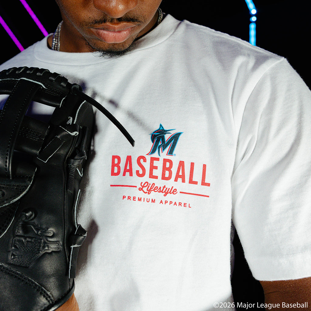 Adult model wearing white graphic tee with "Miami Marlins Ice Cream Cap" design