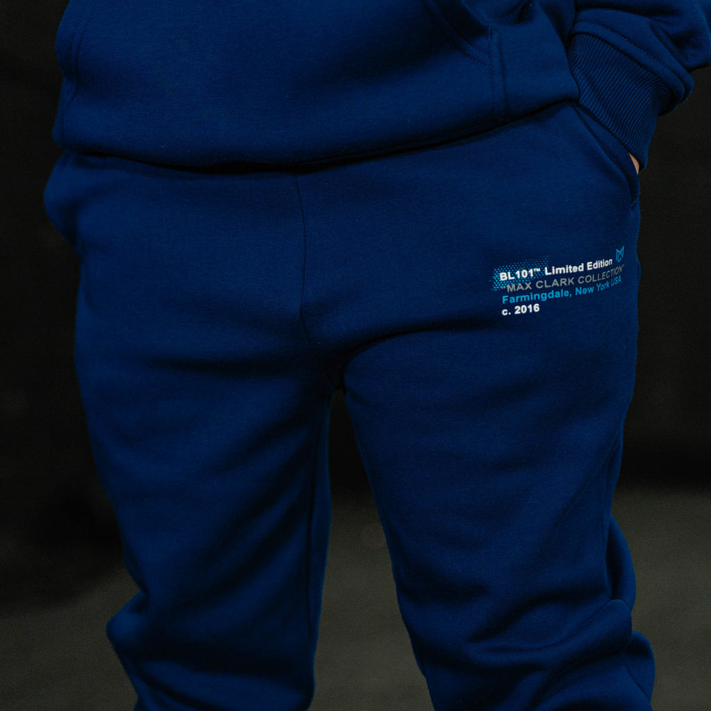 Blue tracksuit with a visible brand label on a dark background