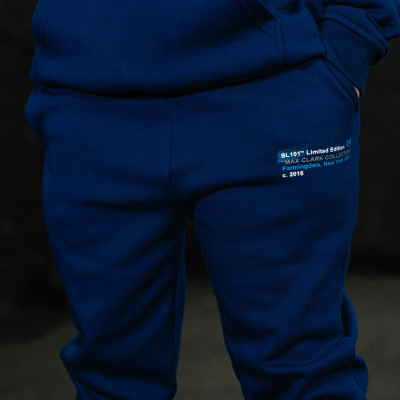 Blue tracksuit with a visible brand label on a dark background