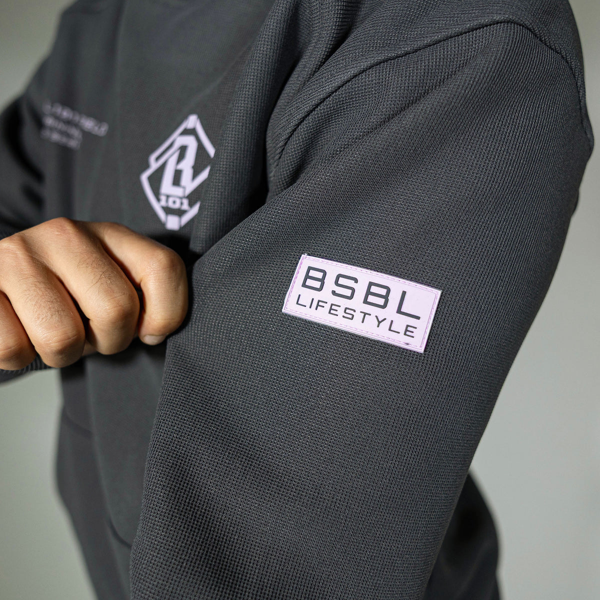Adult model wearing gray and lilac Off-Field Waffle Performance hoodie