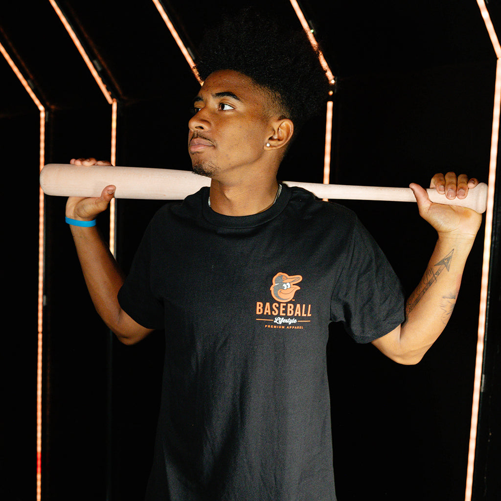 Adult model wearing black graphic tee with "Baltimore Orioles Ice Cream Cap" design