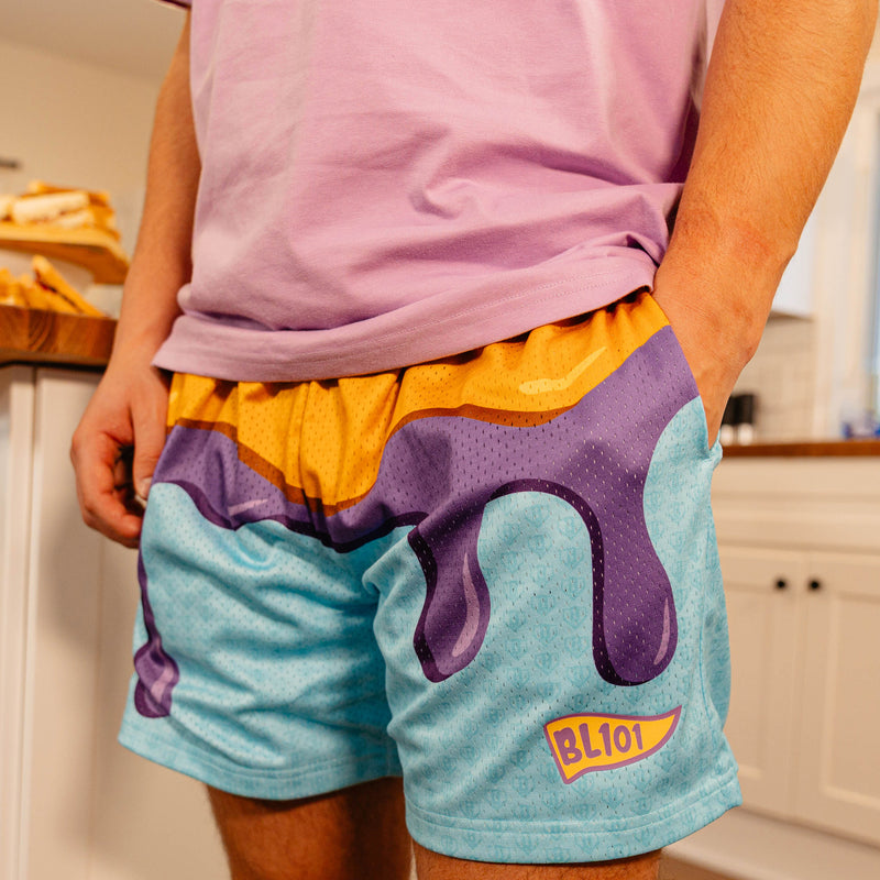 Close-up front view of BL101 PB&J mesh shorts on a male model, showing the dripping jelly graphic and BL101 logo.