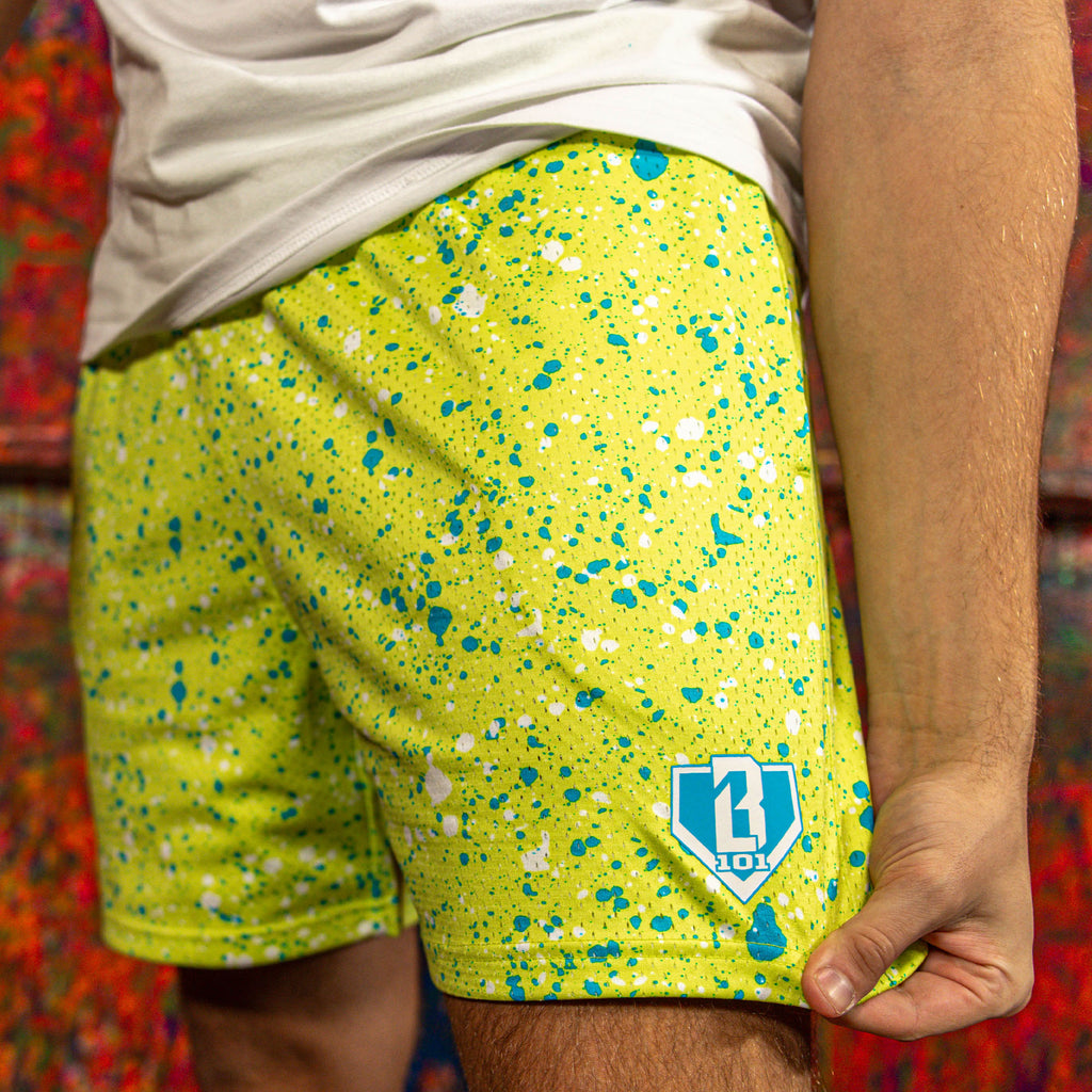 Yellow shorts with blue and white speckles and a BL101 logo on a colorful background
