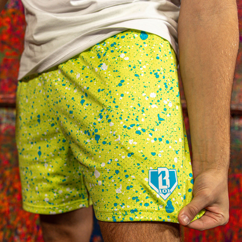 Yellow shorts with blue and white speckles and a BL101 logo on a colorful background