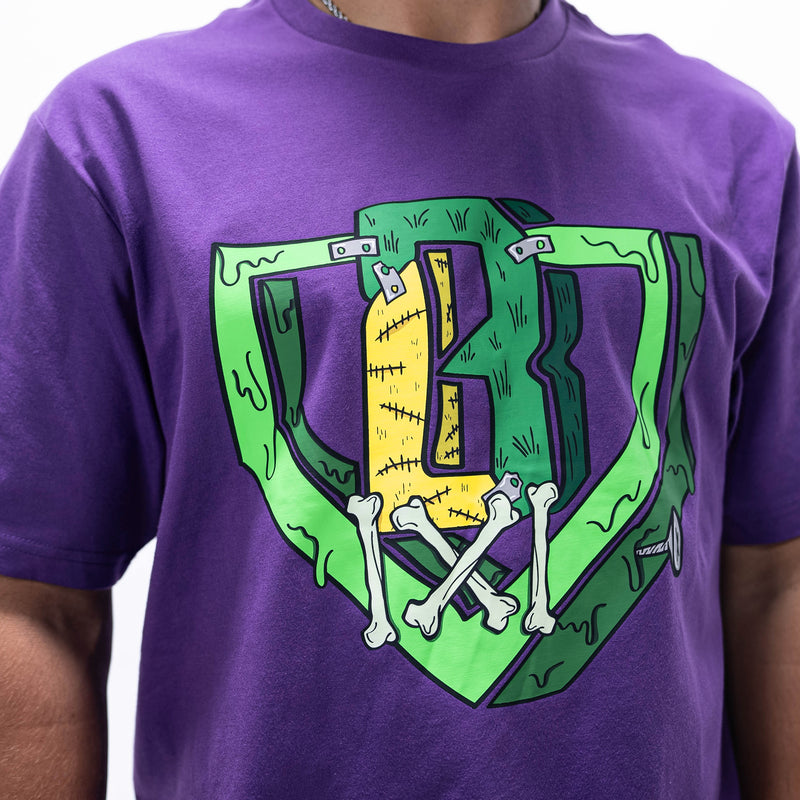 Adult model wearing purple graphic tee with "Spooky SZN Stitch" design