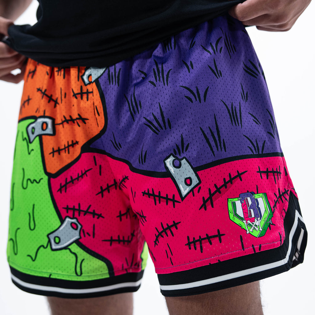 Adult model wearing multi-color shorts with "Stitched For The Show" design
