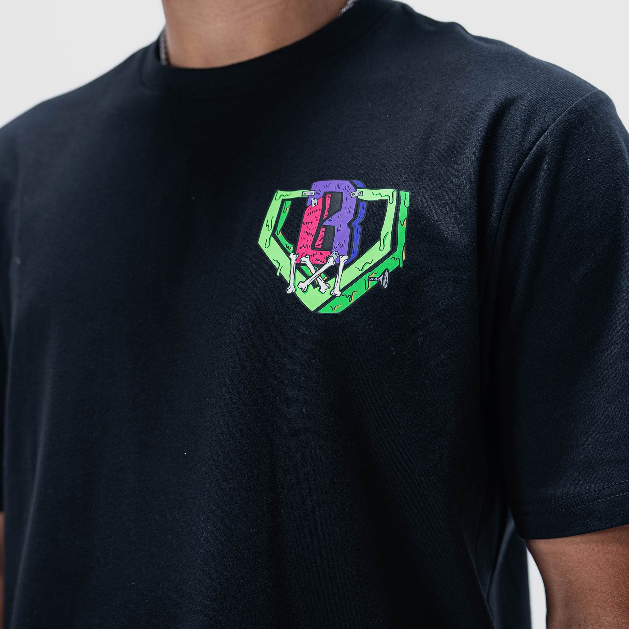 Adult model wearing black graphic tee with "Stitched For The Show" design
