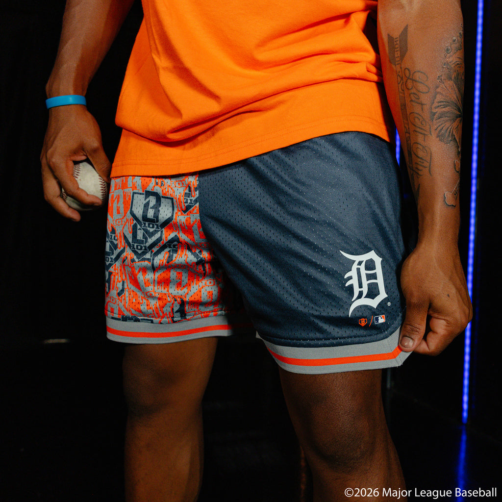 Adult model wearing navy shorts with "Detroit Tigers Sticker Court" design