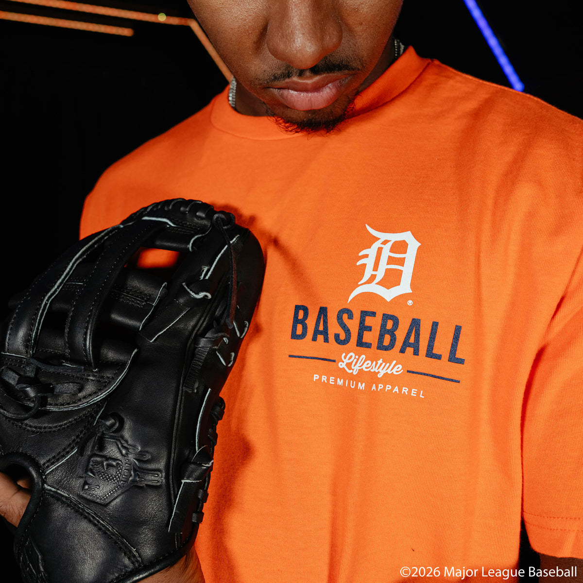 Adult model wearing orange graphic tee with "Detroit Tigers Ice Cream Cap" design