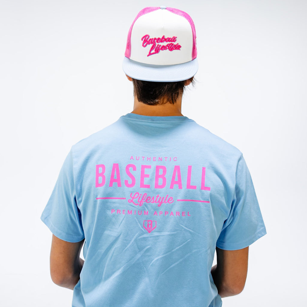 Person wearing a light blue t-shirt and pink and white cap with 'Baseball Lifestyle' logo